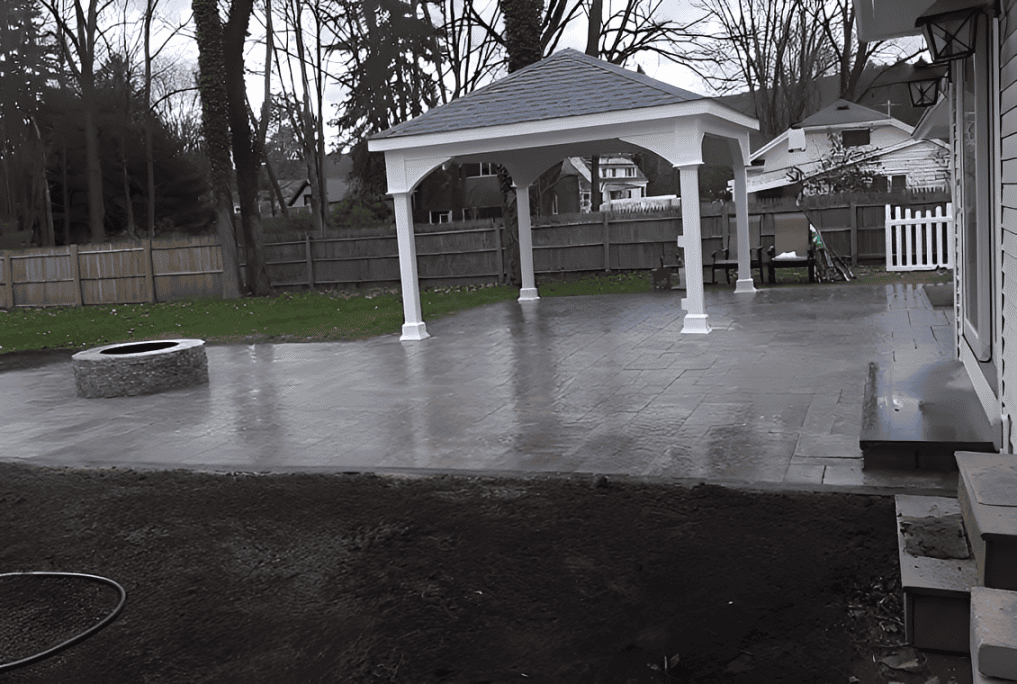 Backyard patio with gazebo and fire pit.