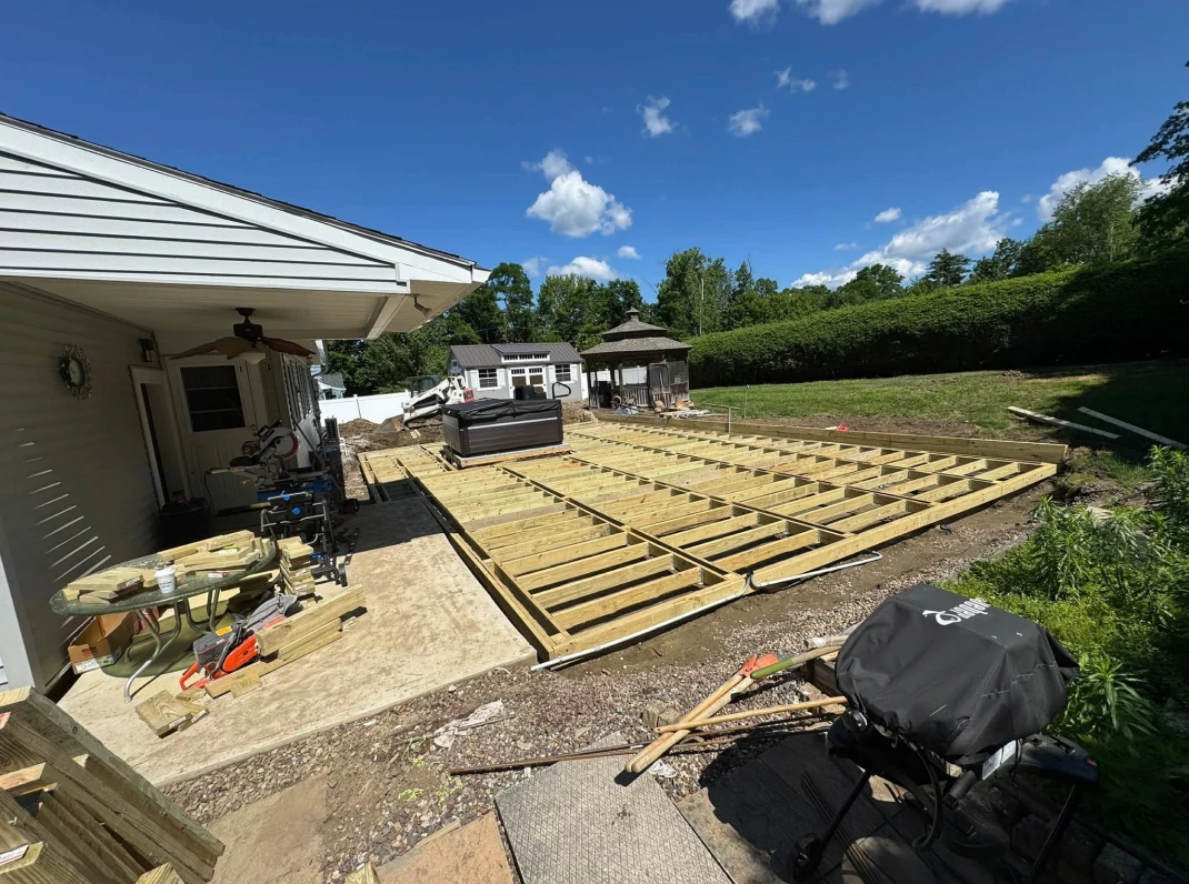 Backyard deck construction on a sunny day.